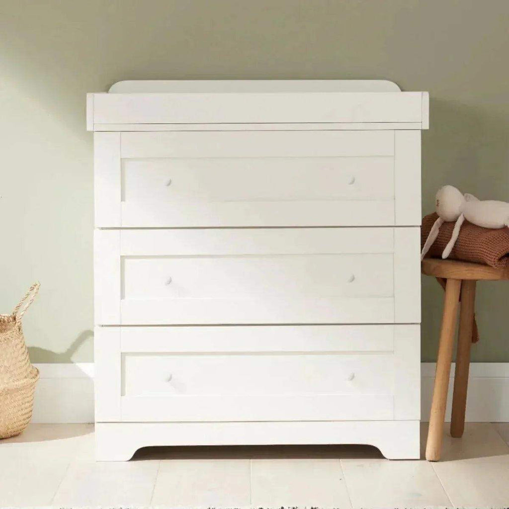 White chest of drawers with three drawers and curved base feet