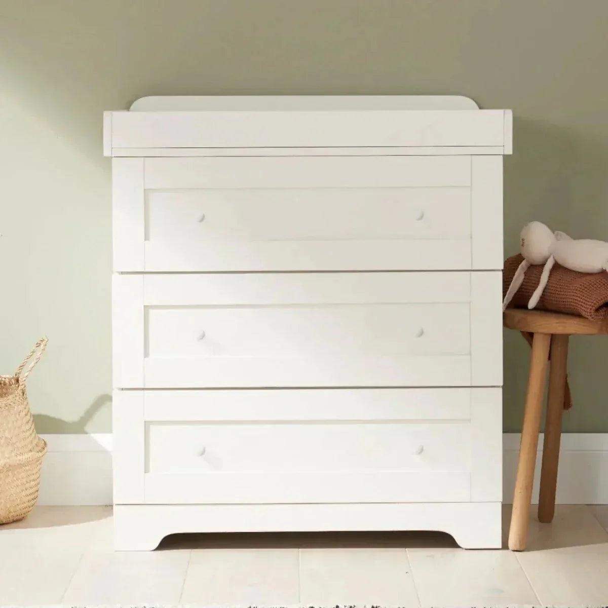 White chest of drawers with three drawers and curved base feet