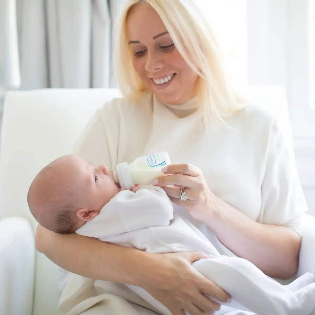 Baby feeding with wide-neck bottle and anti-colic vented nipple