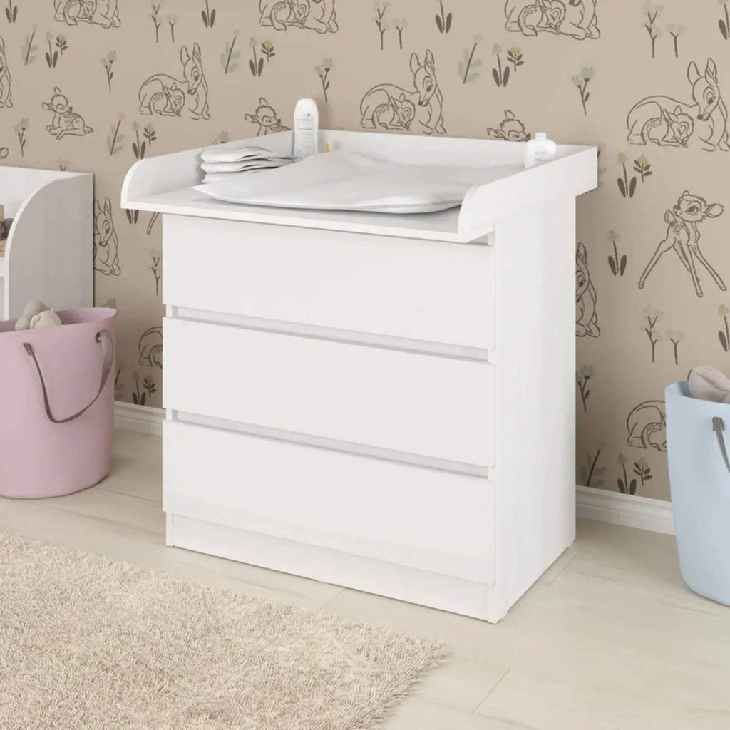White baby changing top on dresser with open tray surface and raised side supports
