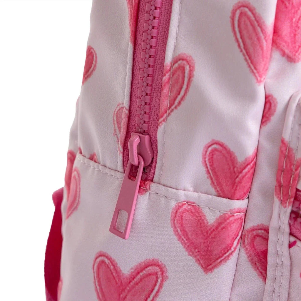 Close-up of pink heart backpack with zip pull and stitched pocket seam