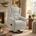 Light grey chenille power lift recliner chair with built-in control panel and studs.