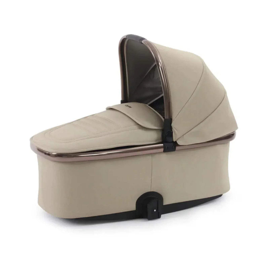 Buttermilk carrycot with padded hood, dark interior trim, and black base