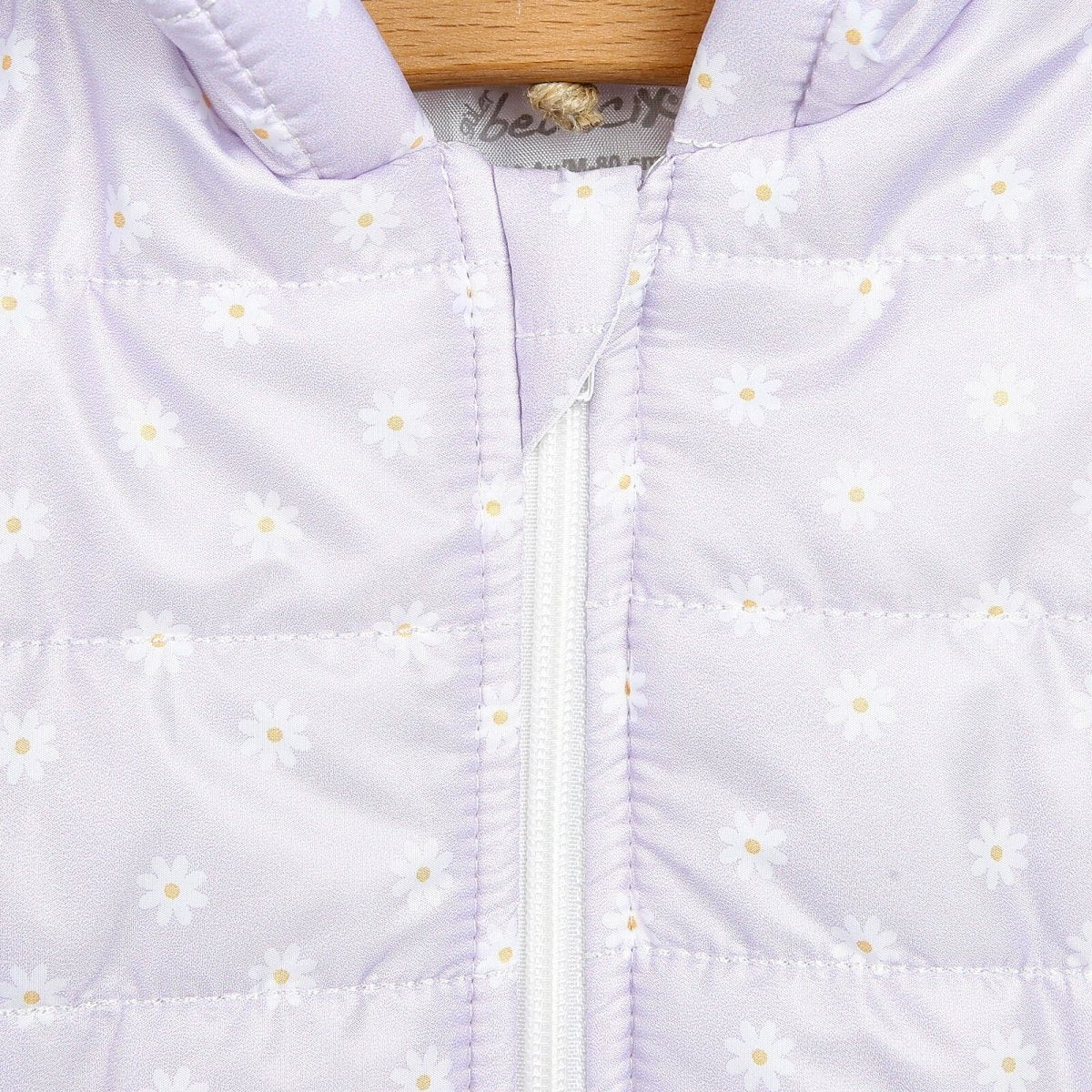 Lilac hooded baby quilted vest with daisy print and front zipper seam detail