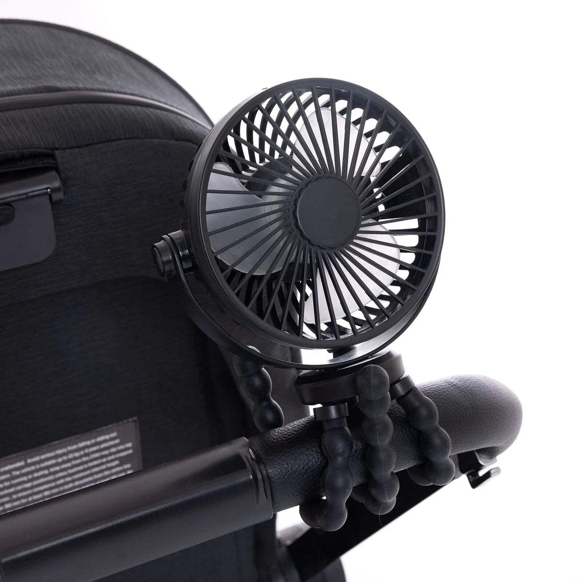 Black stroller fan attached to stroller handlebar with flexible tripod legs