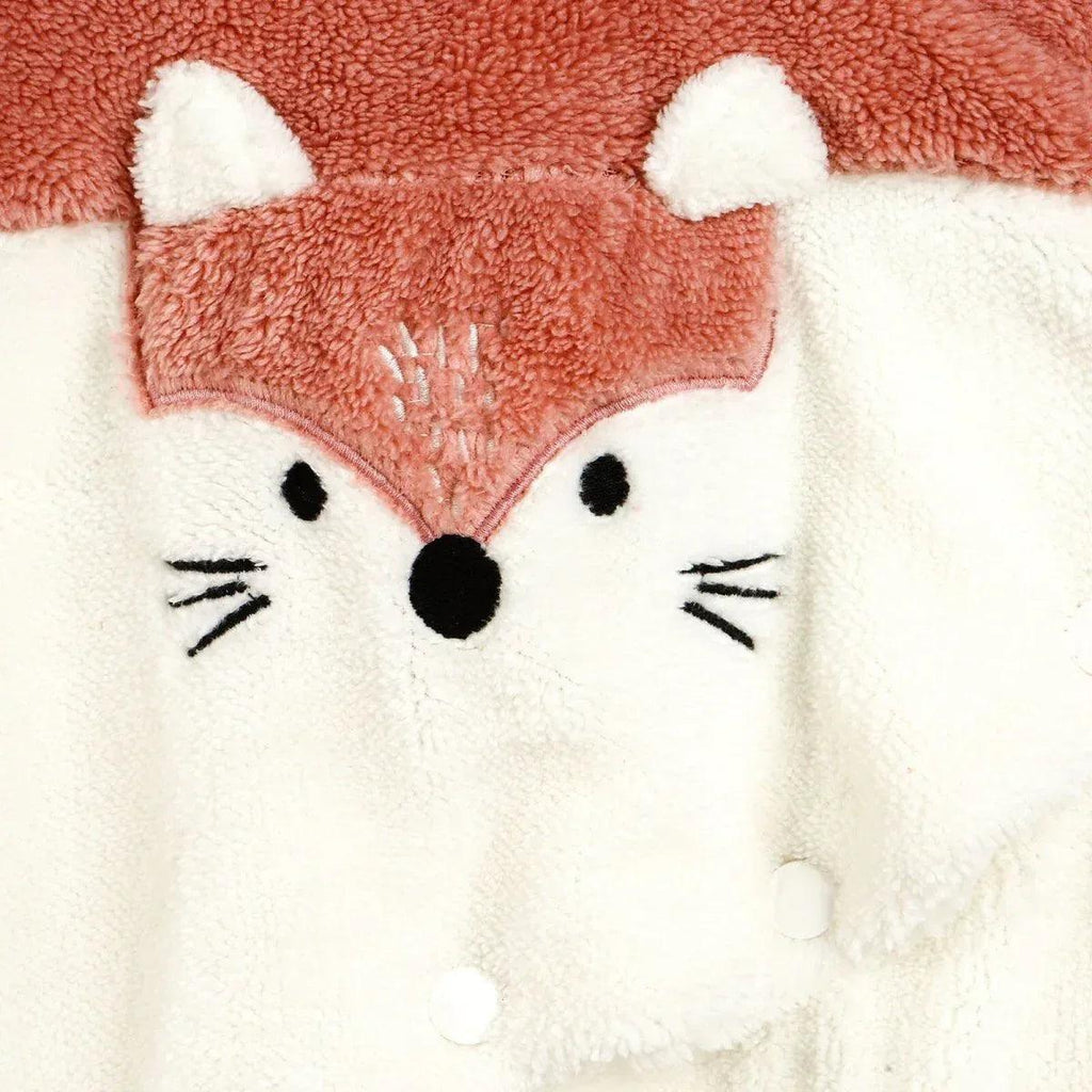 Fox-themed hooded jumpsuit face patch with embroidered eyes and nose on cream panel.