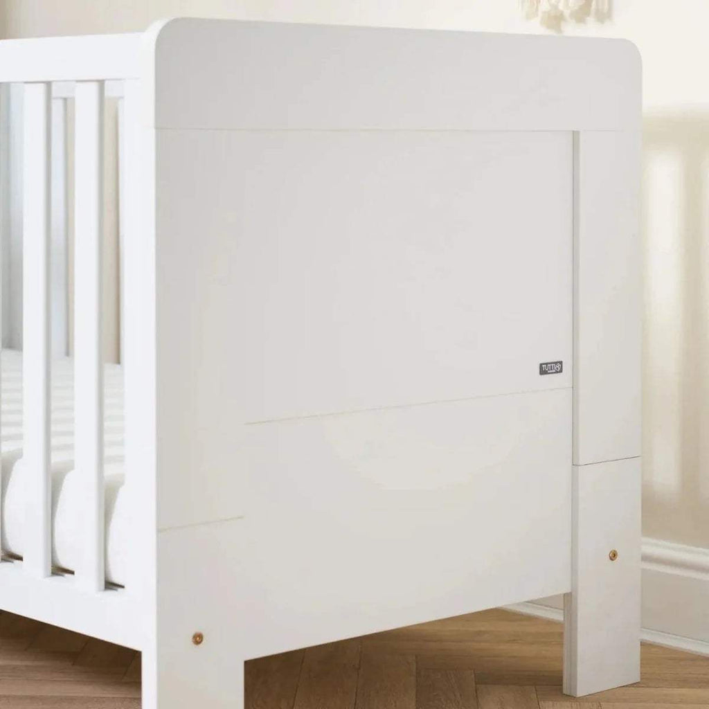 White cot bed end panel with side rail, round feet, and vertical slat guard