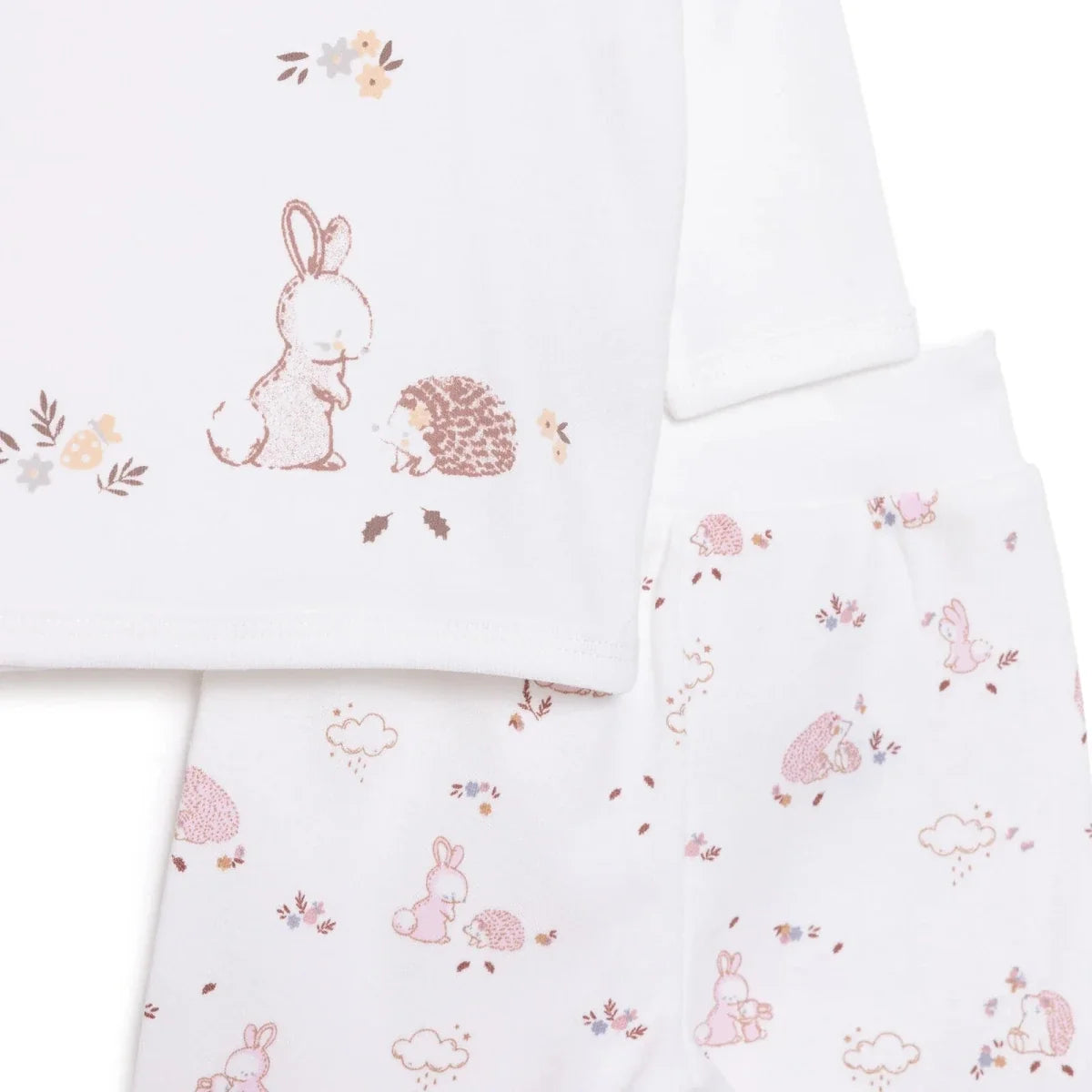 Ecru long-sleeve top and pajama pants with pink rabbits, hedgehogs, and flowers