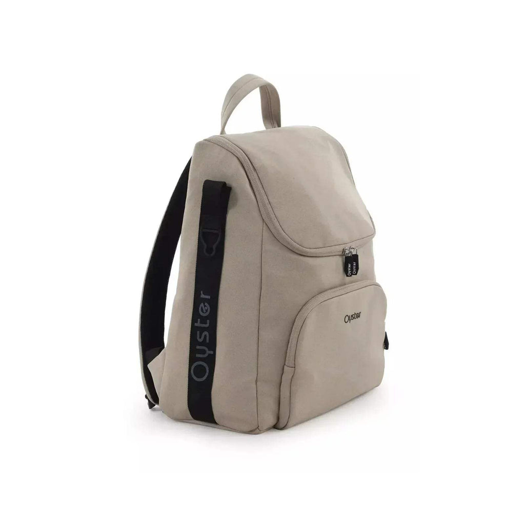 Buttermilk stroller backpack bag with side pocket, top handle, and front zipper detail
