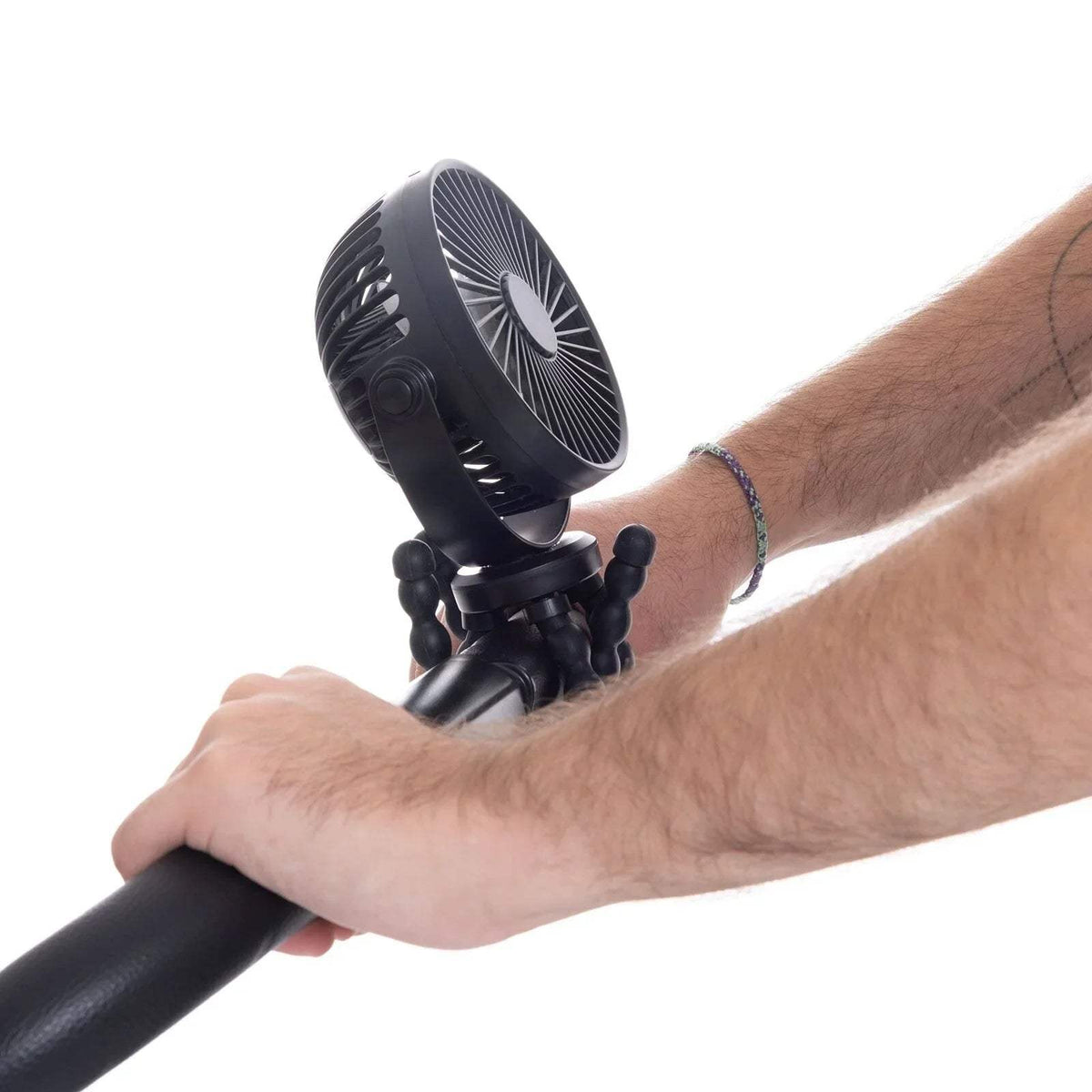 Black stroller fan mounted on handle, showing round front grille and legs