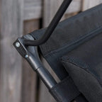 Black mesh zero gravity lounger with metal frame arm and riveted connection