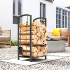 Black metal 2-tier firewood log rack with stacked logs and arched tool hooks.