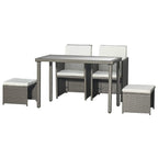 Grey rattan-style dining set with rectangular glass table, two armchairs, and two ottomans
