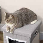 Grey tabby cat lounging on top cushion of a grey fabric cat cube house bed