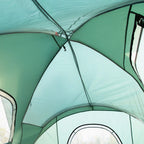Green dome tent interior with curved poles and translucent mesh ceiling