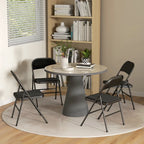 Black folding chair set around a round table, curved padded backs and cushioned seats