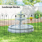 Black metal landscape border fence with arched sections and finial-topped pickets
