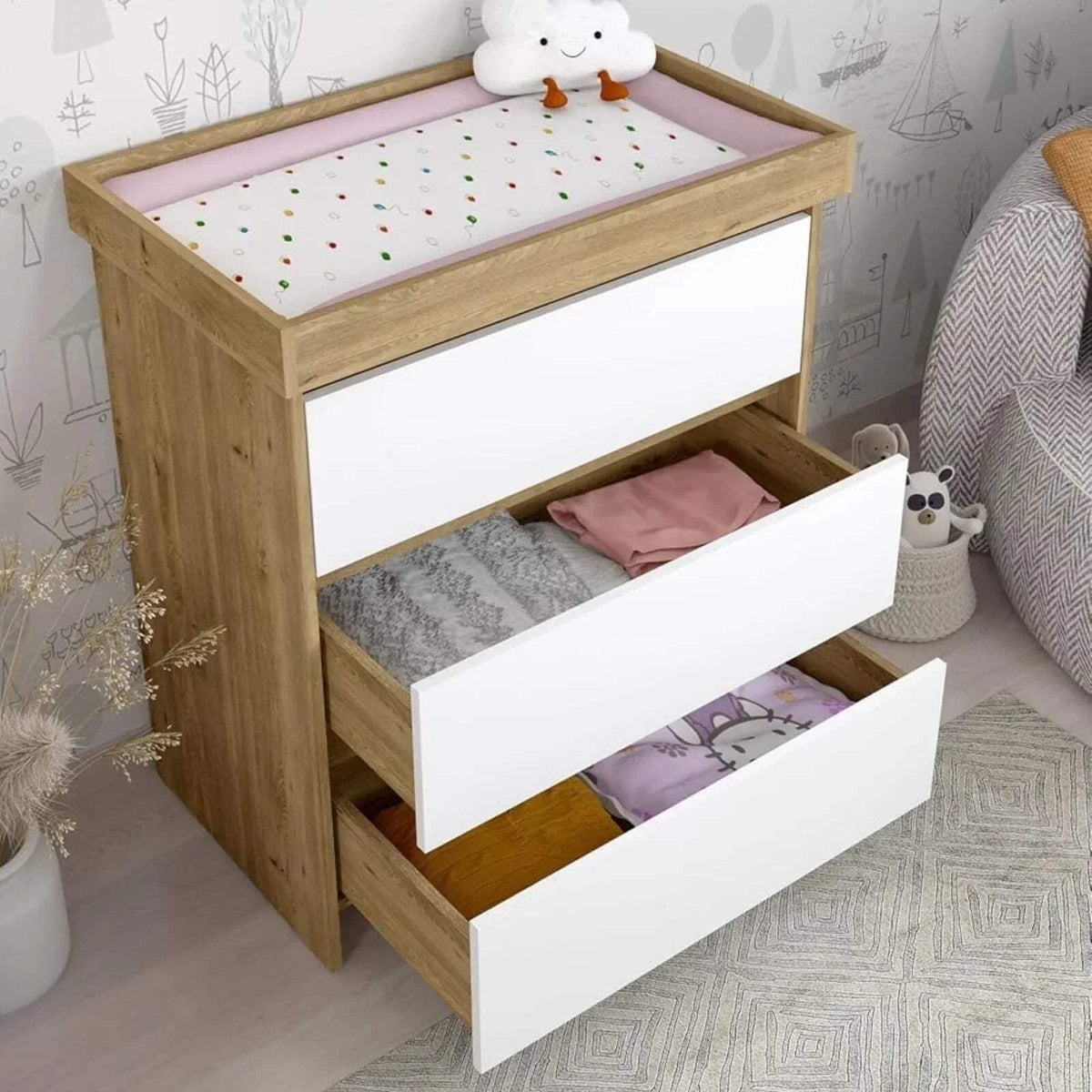 Light oak baby changing unit with open drawer showing changing pad and storage