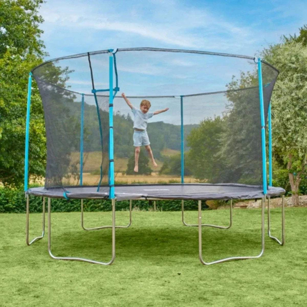 Trampoline with blue poles and gray mesh net, child jumping on mat