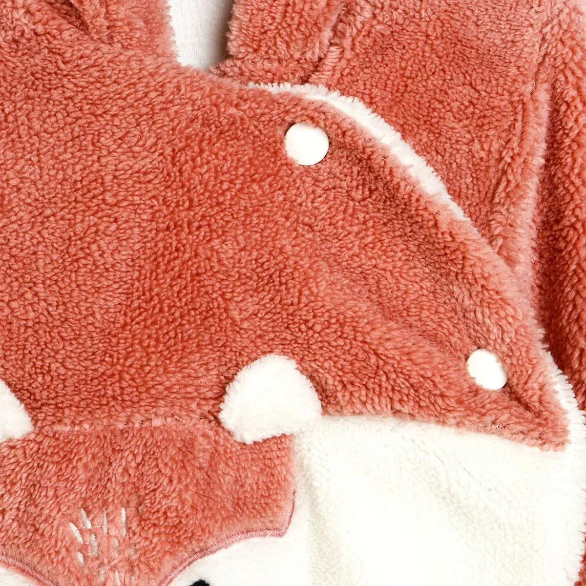 Terracotta teddy fleece bodysuit with cream trim and snap buttons.