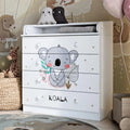 White kids changing dresser with koala graphic, three drawer fronts, and round knob pulls