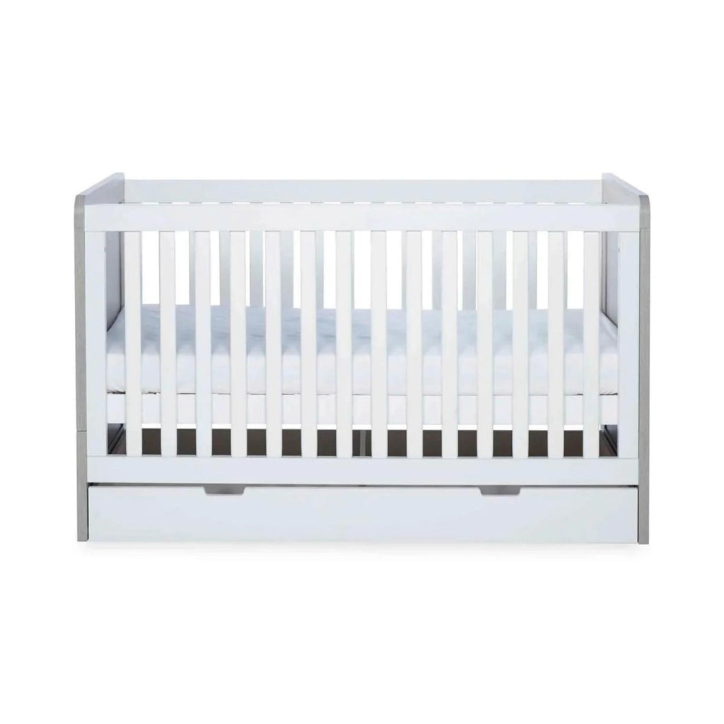 Grey-and-white baby cot rear view with vertical safety bars