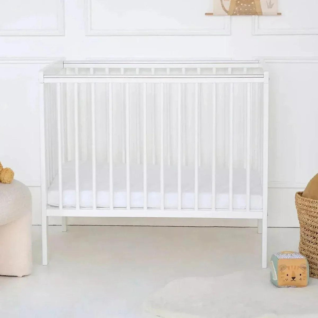 White space saver cot with vertical slat sides and low profile frame