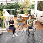 Grey outdoor bistro set with two folding chairs and round glass-top table outdoors