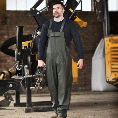 Green waterproof bib and brace overalls worn by a worker with adjustable braces