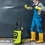 Green pressure washer with spray gun, standing on wheels for outdoor cleaning