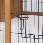 Black latch handle on wire mesh door inside a wooden rabbit hutch