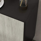 Sideboard cabinet corner with light-wood door panel edge and black tabletop