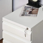 White metal filing cabinet top drawer with key lock and keys attached to the front.
