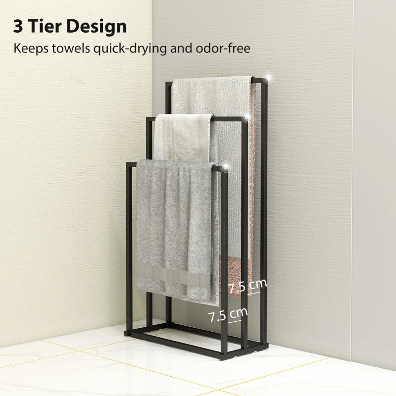 Black 3-bar towel rack with thick gray towels hanging over the bars.