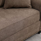 Brown fabric sofa arm and seat cushion with nailhead trim along the edge