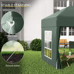 Green pop-up gazebo with white window panel and visible guy ropes and ground stakes