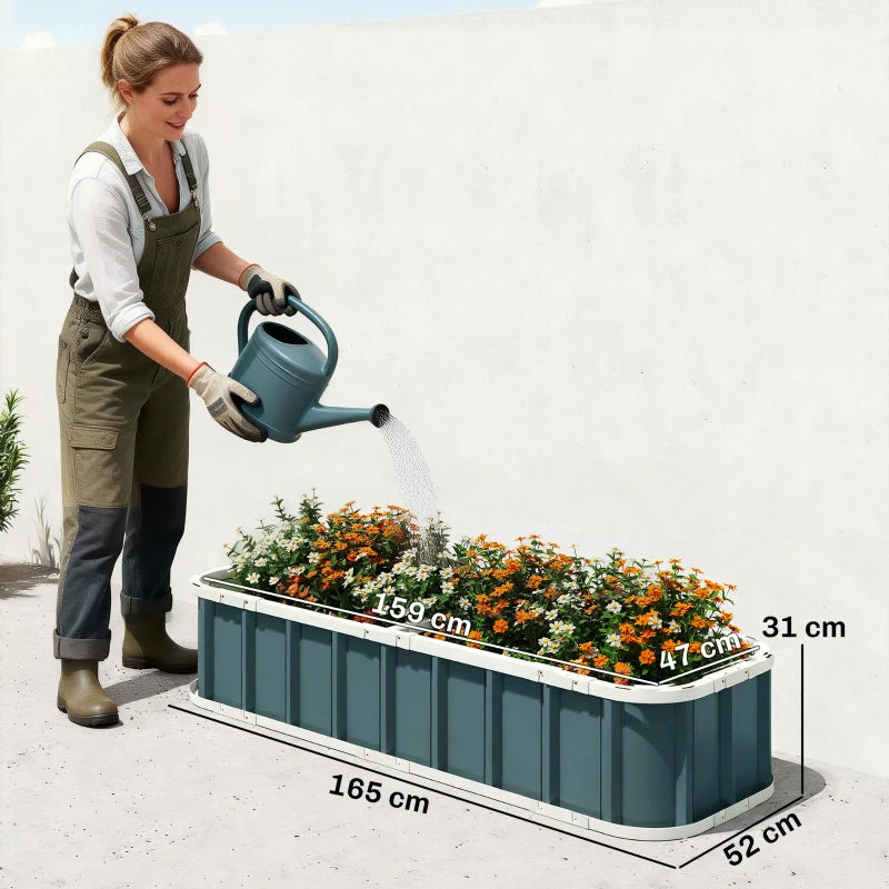 Dark grey metal raised garden bed being watered, with visible length and width