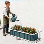 Dark grey metal raised garden bed being watered, with visible length and width