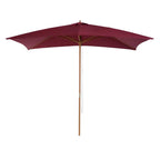 Wine red garden parasol with open canopy and wooden center pole.