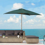 Green garden parasol standing with open canopy and wooden pole