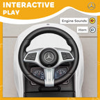 Close-up of black steering wheel and dashboard on white ride-on car walker