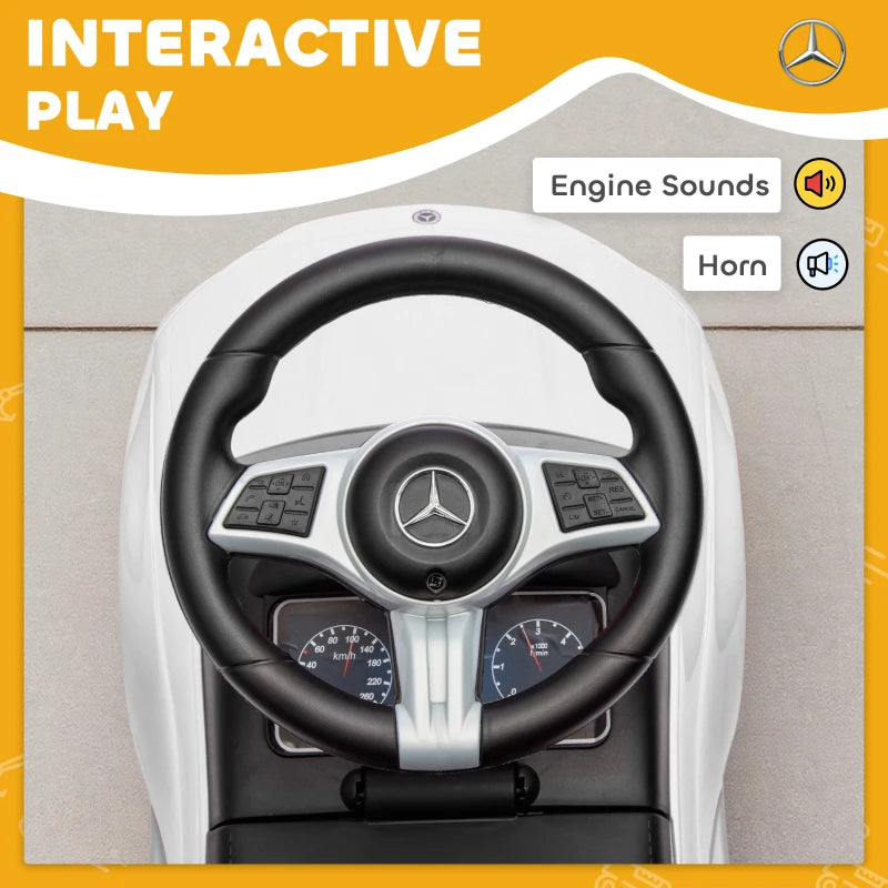 Close-up of black steering wheel and dashboard on white ride-on car walker