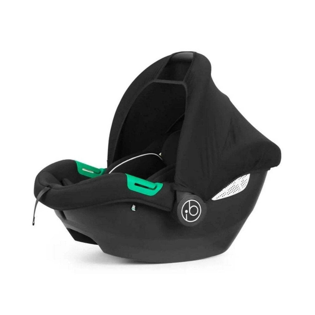 Black i-Size infant car seat with ISOFIX base, front view with green handle accents