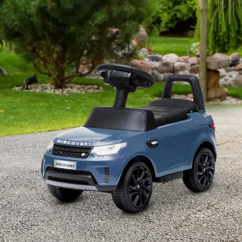 Light blue kids electric ride-on car with black seat, steering wheel, and rearview details