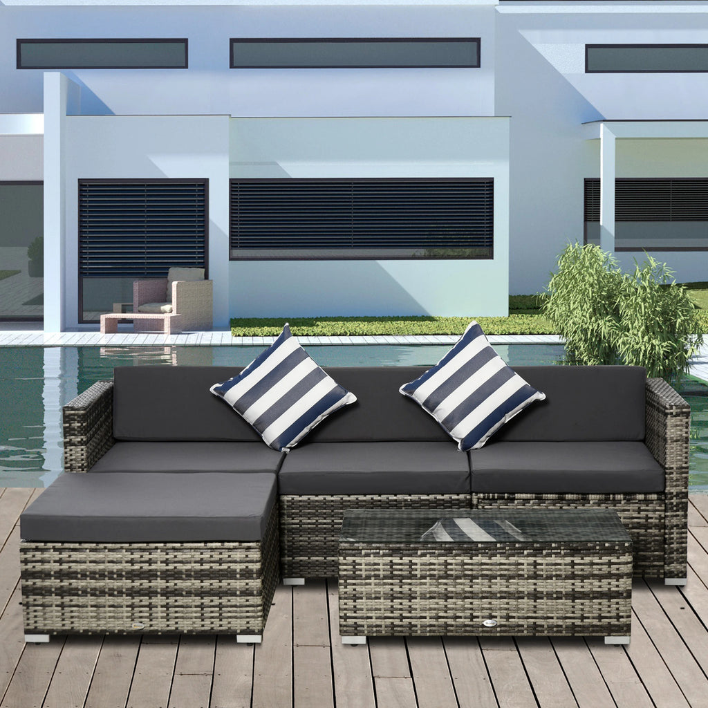 Grey wicker sectional sofa set with chaise, dark cushions, striped pillows and matching table