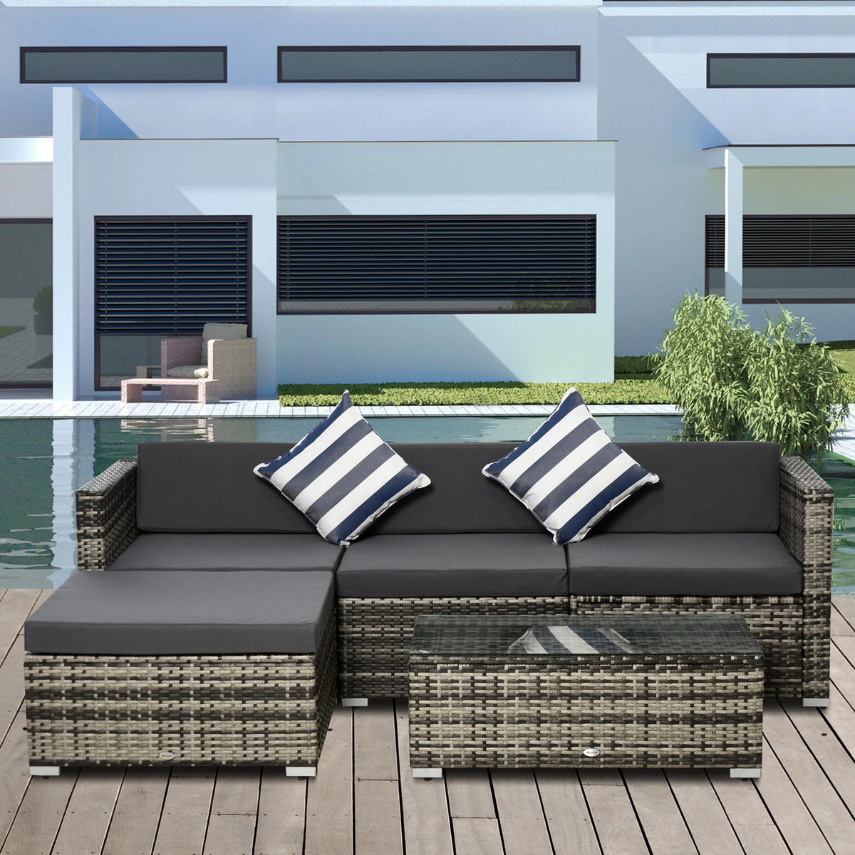 Grey wicker sectional sofa set with chaise, dark cushions, striped pillows and matching table