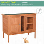 Elevated wooden pet hutch with lockable doors, metal mesh windows, and green roof cover