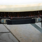 Underside view of rattan sun lounger with metal latch and black support strap