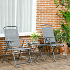 Light grey folding patio chairs with round glass-top table on wooden deck