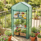 Green mesh three-tier mini greenhouse with wire shelves and potted plants inside